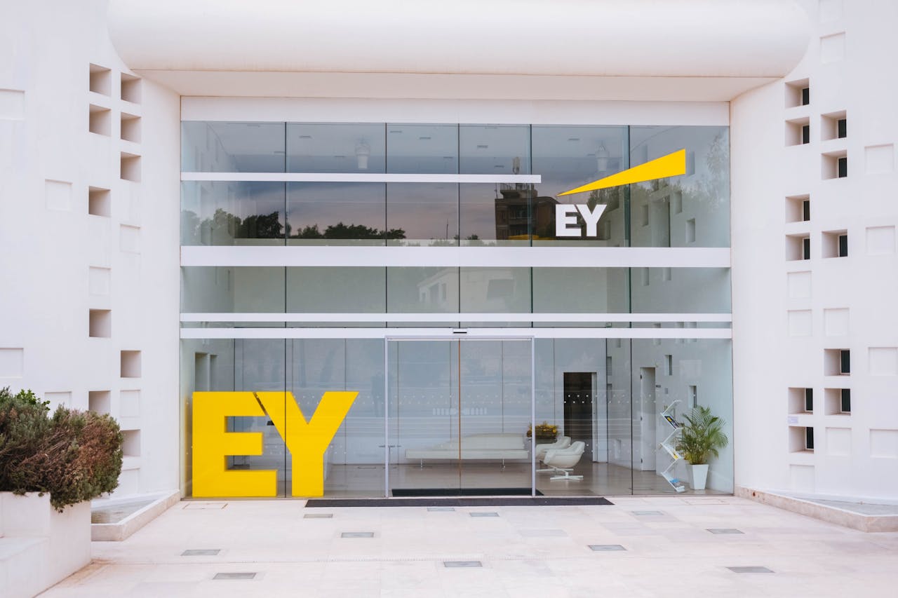 Exterior view of a corporate building entrance with EY logo and minimalist design.